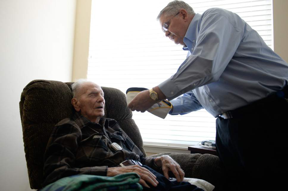 Francisco Kjolseth | The Salt Lake Tribune
Max Burggraaf, 98, one of Utah's last Pearl Harbor survivors, is helped with his hat by his son Sam at his retirement home in South Jordan.