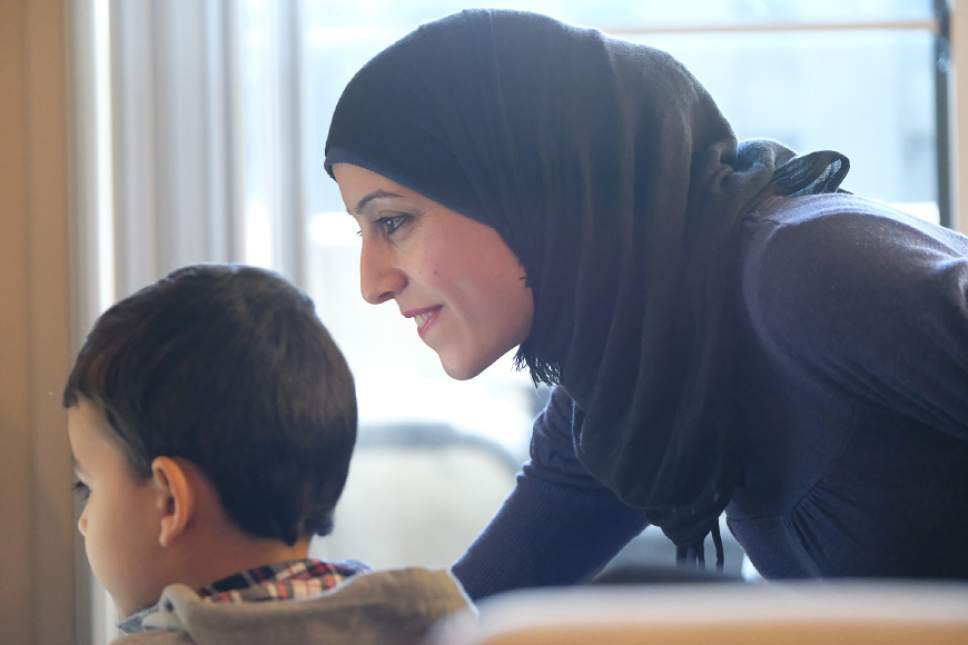 Francisco Kjolseth | The Salt Lake Tribune
Keeping her children occupied as she shares her experience of leaving the war torn country of Syria, Rasha Ismaeel Al Kilani and her husband Ali Mohammad Al Soufani have finally made their way to Utah.
