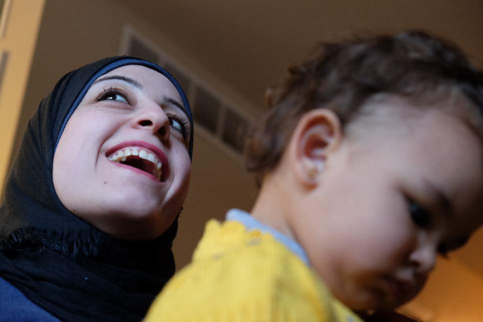 Francisco Kjolseth | The Salt Lake Tribune
Rasha Ismaeel Al Kilani hold her daughter Sima Ali Mohammad, 22-months, as she talks about a new beginning in Utah along with her husband and two children. The family fled the war in Syria in 2013. After four years in Jordan they were finally cleared by immigration. Now with the help of Catholic Community Services, they have spent their first two weeks in Utah.