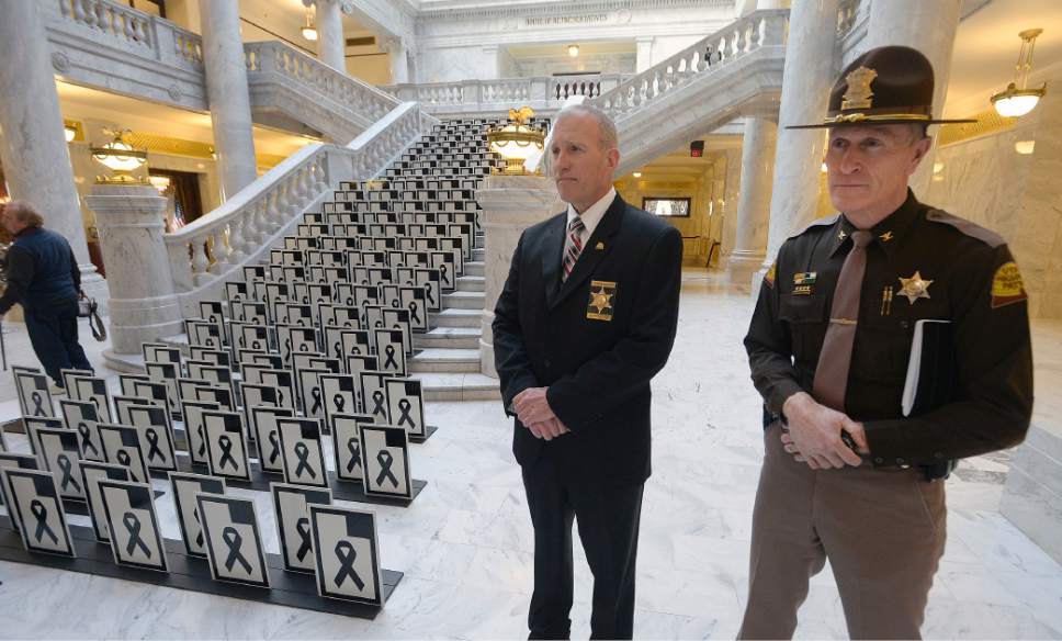 Al Hartmann  |  The Salt Lake Tribune 
Dept. of Public Safety Commissioner Keith Squires, left, and UHP Colonel Michael Rapich stand next to markers representing the 280 lives lost on Utah roads in 2016 placed on the stairway at the Utah State Capitol rotunda Wednesday Jan 18.  It's a memorium to serve as a reminder to put safety first while driving.