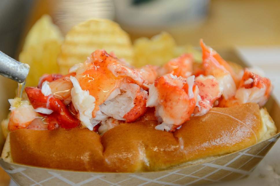 Trent Nelson  |  The Salt Lake Tribune
A lobster roll gets a layer of hot butter at Freshie's Lobster Co. in Park City.