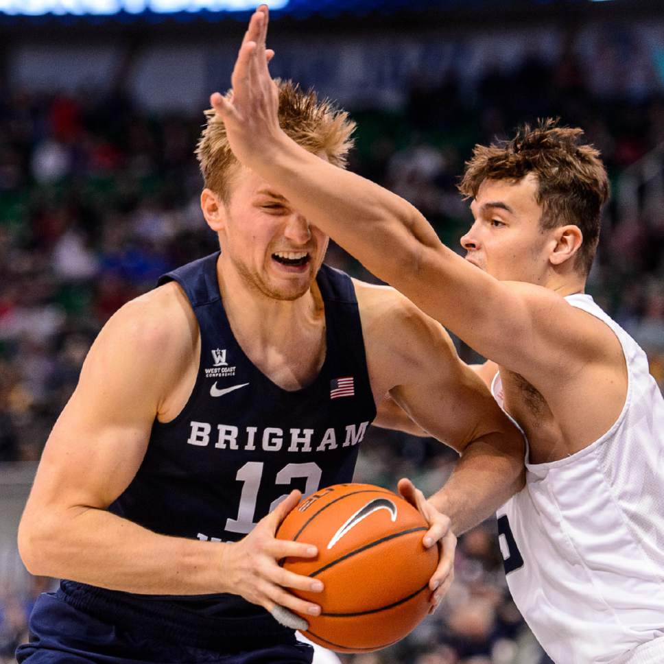 Trent Nelson  |  The Salt Lake Tribune
Brigham Young Cougars forward Eric Mika (12) defended by Utah State Aggies forward Norbert Janicek (15) as BYU faces Utah State, NCAA basketball in Salt Lake City, Wednesday November 30, 2016.