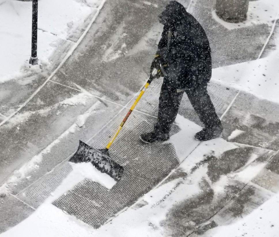 Al Hartmann  |  The Salt Lake Tribune
Maintenance workers keeps up with the snow falling Thursday Jan. 19 at the Gateway in Salt Lake City.  Stay turned for a few days of small storms.