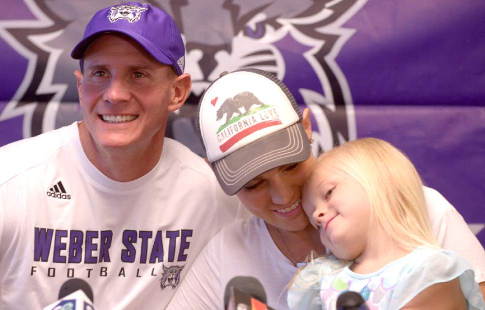 Leah Hogsten  |  The Salt Lake Tribune
Sara Hill hugs her daughter Allie, 5, after she and her husband, Weber State football coach Jay Hill, talked about her battle with Hodgkins lymphoma and how the Wildcat family has rallied around her and her husband at Stewart Stadium, Wednesday, August 24, 2016. Weber State football players, coaches and family and friends shaved their heads in support of her chemotherapy treatments.