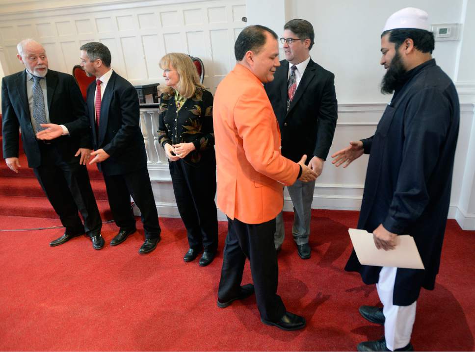 Al Hartmann  |  The Salt Lake Tribune
Rev. Dr. Pablo Ramos, right, shakes hands with Imam Shuaib Din and other religious leaders at the conclusion of an Inauguration Interfaith Prayer Service at the First Unitarian Church in Salt Lake City Friday Jan. 20 as Donald Trump  takes the oath of office to become the next President of the United States. Clergy from several denoninations and faiths spoke words of encouragement, peace and solidarity.