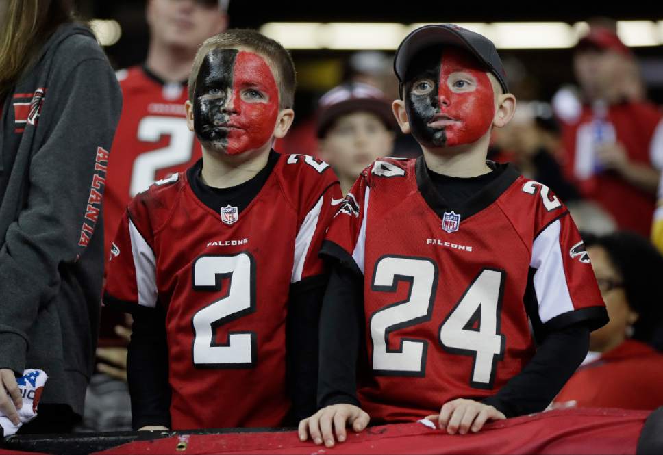Some young Atlanta Falcons fans watch warm ups before the NFL football NFC ...