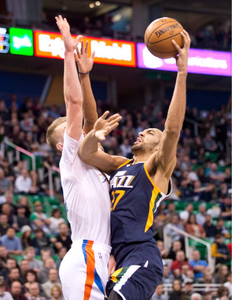 Lennie Mahler  |  The Salt Lake Tribune

Joe Ingles kicks the ball out to the perimeter as he is defended by Domantas Sabonis in a game against the Oklahoma City Thunder on Monday, Jan. 23, 2017, at Vivint Smart Home Arena in Salt Lake City.