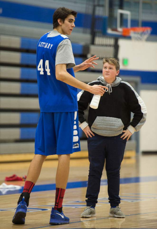 Steve Griffin / The Salt Lake Tribune

Pleasant Grove sophomore Matthew Van Komen is 7-foot-3 and one of the main reasons the Vikings are off to a 10-1 start this season. He is pictured here during practice at Pleasant Grove High School in Pleasant Grove Wednesday January 4, 2017. Here a stands with Pleasant Grove High School basketball team manager Derek "Big Daddy" Leetham as he hydrates during a time out.