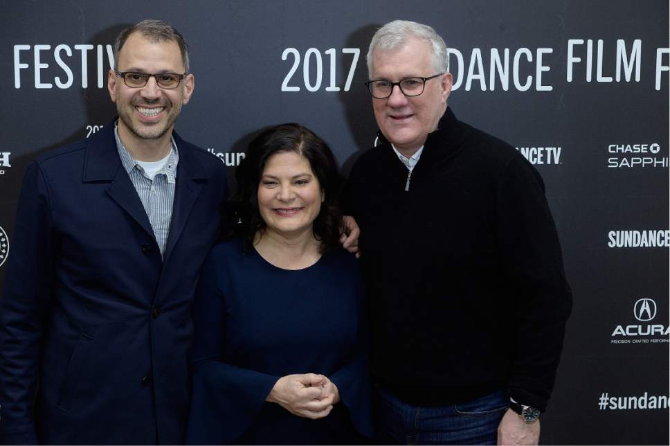 Scott Sommerdorf   |  The Salt Lake Tribune  
John Shenk, left, co-director and cinematographer, Bonnie Cohen, co-director, and David Linde, right, CEO of Participant Media, pose for photos while passing down the red carpet at the premiere of "An Inconvenient Sequel: Truth to Power," at the Eccles Theatre in Park City, Thursday, Jan.19, 2017.