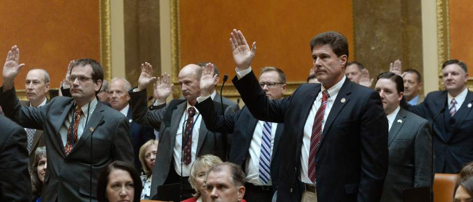 Al Hartmann  |  The Salt Lake Tribune
Returning members of the House of Representatives raise their hands for the oath of office Monday Jan. 23 during the first day of the 2017 Legislative session at the Utah State Capitol.