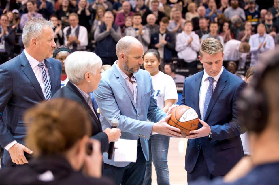 Lennie Mahler  |  The Salt Lake Tribune

Gail Miller, owner and chairman of The Larry H. Miller Group of Companies, passes an historic ball from a 1985 game along to family members Greg Miller, Steve Miller and Zane Miller to symbolize the transfer of team ownership during a game against the Oklahoma City Thunder Monday, Jan. 23, 2017.