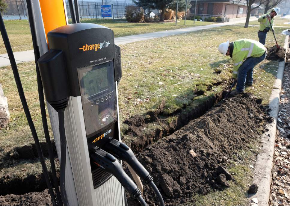 Francisco Kjolseth | The Salt Lake Tribune
Crews work to install a total of four electric car charging stations at Liberty park in Salt Lake on Wednesday, Jan. 18, 2017. The city is upgrading its six current electric car charging stations and adding more, giving electric car owners a total of 28 city-owned charge ports within city boundaries. The downside for electric car owners is the new stations will eventually allow the city to recoup energy costs by charging a fee that's been on the books but unenforceable previously.