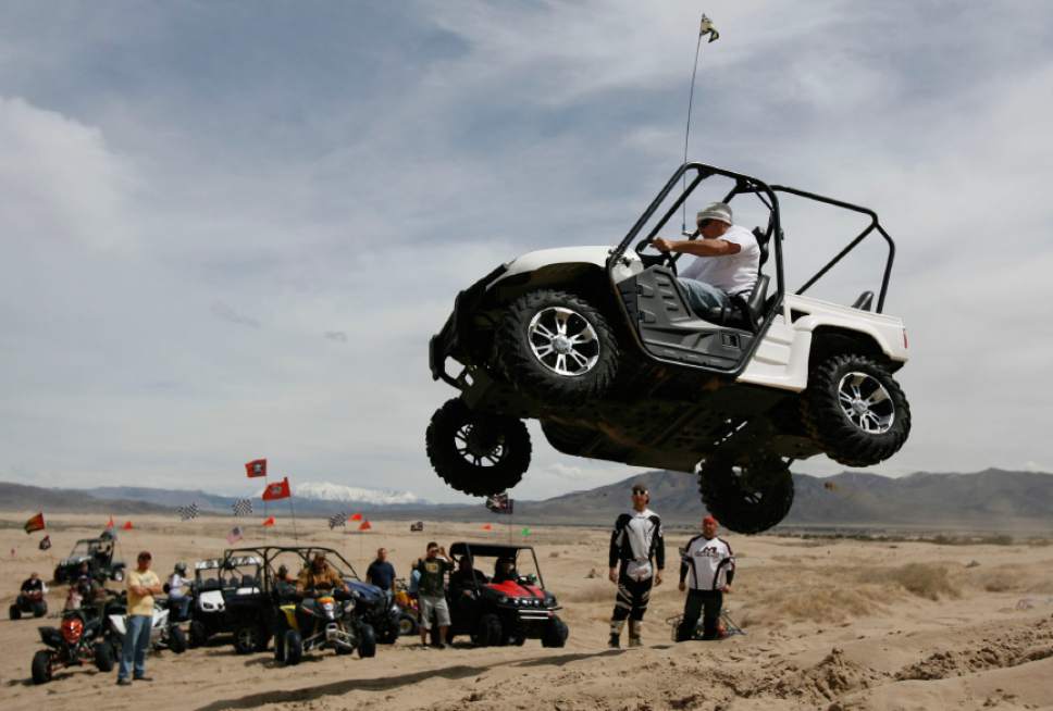 Francsco Kjolseth  |  Tribune file photo
Chevy Hastings of Spanish Fork puts hits Yamaha Rhino to the test at Little Sahara Recreation Area. Sand Mountain, the largest sand dune in the recreation area, is a popular spot for hill climbers.