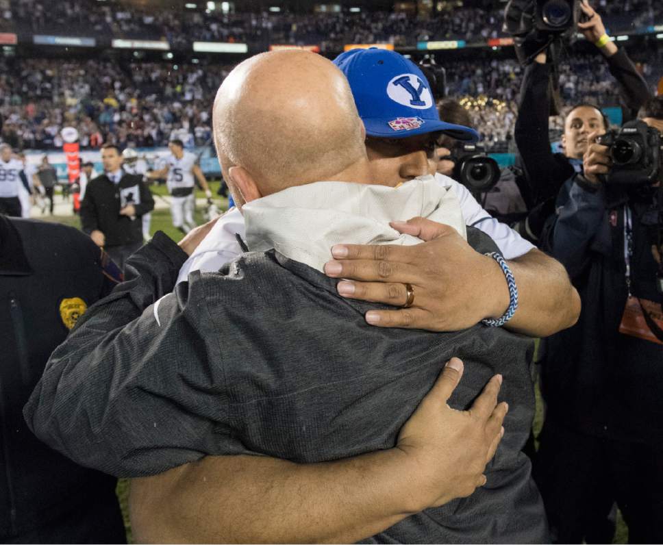 Rick Egan  |  The Salt Lake Tribune

Brigham Young Cougars head coach Kalani Sitake hugs Wyoming Cowboys head coach Bio for Craig Bohl after BYU defeated Wyoming 24-21in the Poinsettia Bowl, at Qualcomm Stadium in San Diego, December 21, 2016.