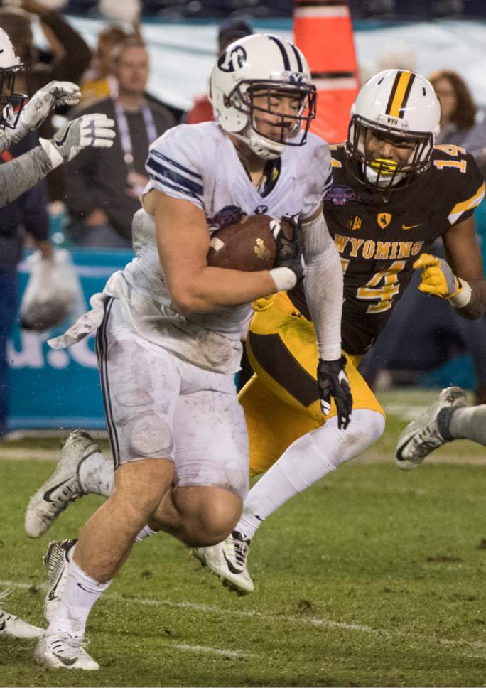 Rick Egan  |  The Salt Lake Tribune

Brigham Young defensive back Kai Nacua (12) runs with the ball after intercepting a pass by Wyoming Cowboys quarterback Josh Allen (17) to win the game for the Cougars, as BYU defeated Wyoming 24-21in the Poinsettia Bowl, at Qualcomm Stadium in San Diego, December 21, 2016.