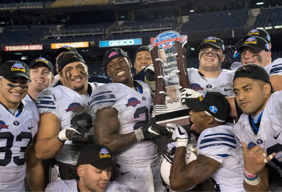 Rick Egan  |  The Salt Lake Tribune

The Brigham Young Cougars celebrate their win with the trophy, as BYU defeated Wyoming 24-21in the Poinsettia Bowl, at Qualcomm Stadium in San Diego, December 21, 2016.