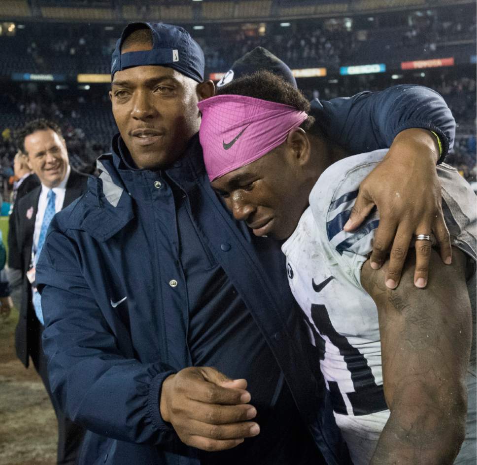 Rick Egan  |  The Salt Lake Tribune

Brigham Young cornerbacks coach, Jernaro Gilford walks off the field with Brigham Young Cougars running back Jamaal Williams (21), who rushed for 210 yards, and won the offensive MVP trophy, as BYU defeated Wyoming 24-21in the Poinsettia Bowl, at Qualcomm Stadium in San Diego, December 21, 2016.