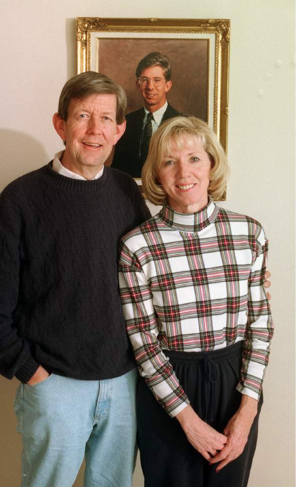 Tribune File Photo
Sherm and Karen Watkins in their Provo home with picture of their son, Brian, who was murdered in 1990 on a trip to New York City.