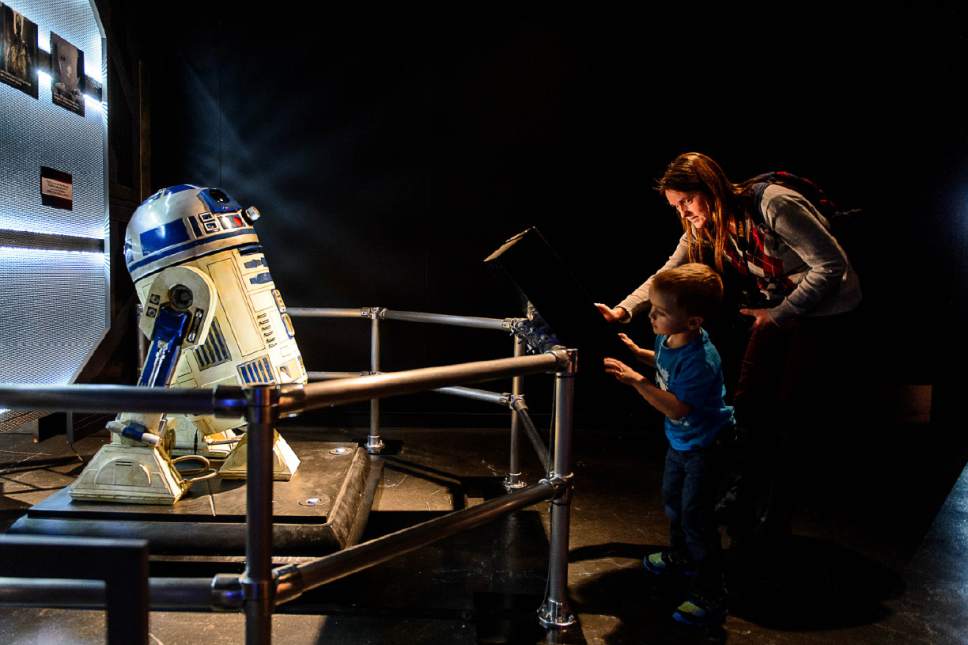 Trent Nelson  |  The Salt Lake Tribune
Natalie and Seth Ockey interact with R2D2 at The Leonardo's new exhibit "Alien Worlds and Androids," which opens Saturday, Jan. 28.