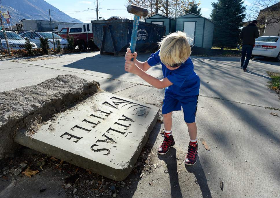 Scott Sommerdorf   |  The Salt Lake Tribune  
The old Atlas Title sign that was on the north side of the property is broken up during a work / cleanup day at the old Victorian home being renovated to house "Encircle House" which will be Provo's first LGBT resource center, Saturday November 19, 2016.