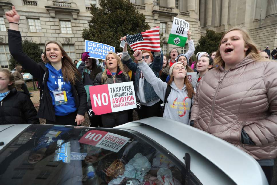 Participants in the March for Life cheer as they march to Supreme Court from the National Mall in Washington, starts Friday, Jan. 27, 2017. (AP Photo/Manuel Balce Ceneta)
