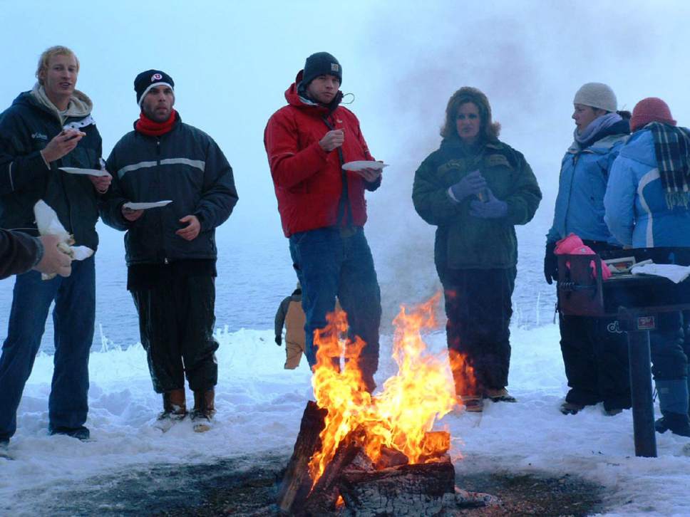 Arrin Newton Brunson  |  Tribune File Photo
Fishermen and their friends gather around the fire at the annual Cisco Disco,  named for the hopping around fish dippers do to stay warm.  Cisco fish are spawning this week and can be netted on the east side of Bear Lake along the rocky shoreline.