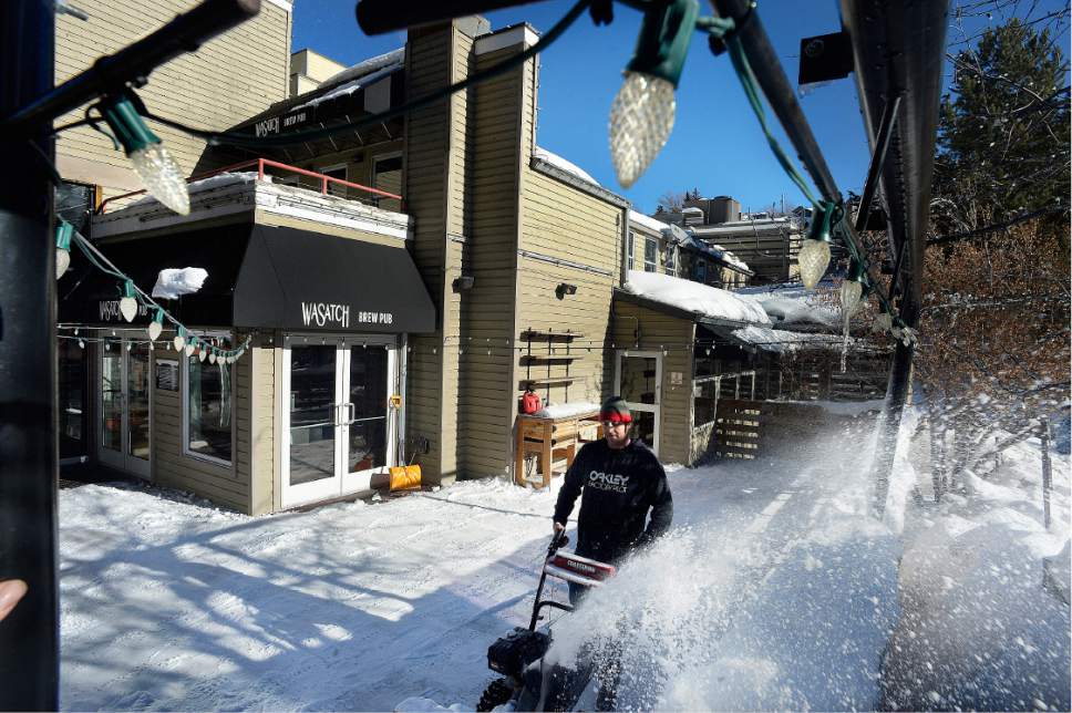 Scott Sommerdorf   |  The Salt Lake Tribune  
Mic hale Oren snowplows the patio at Wasatch Brew Pub at the top of Main Street as delivery trucks and visitors made for crowded energy in Park City prior to the beginning of the Sundance Film Festival on Wednesday, Jan. 18, 2017.