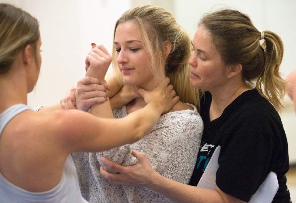 Leah Hogsten  |  The Salt Lake Tribune
Sasha Trae, right, assists Mindi Harris, 19, as she tries to maneuver out of a strangle hold in Trae's class. Dixie State University instructor Sasha Trae teaches a 16-week course on abusive relationships and self-protection to create gender equality, respect and healthy boundaries.