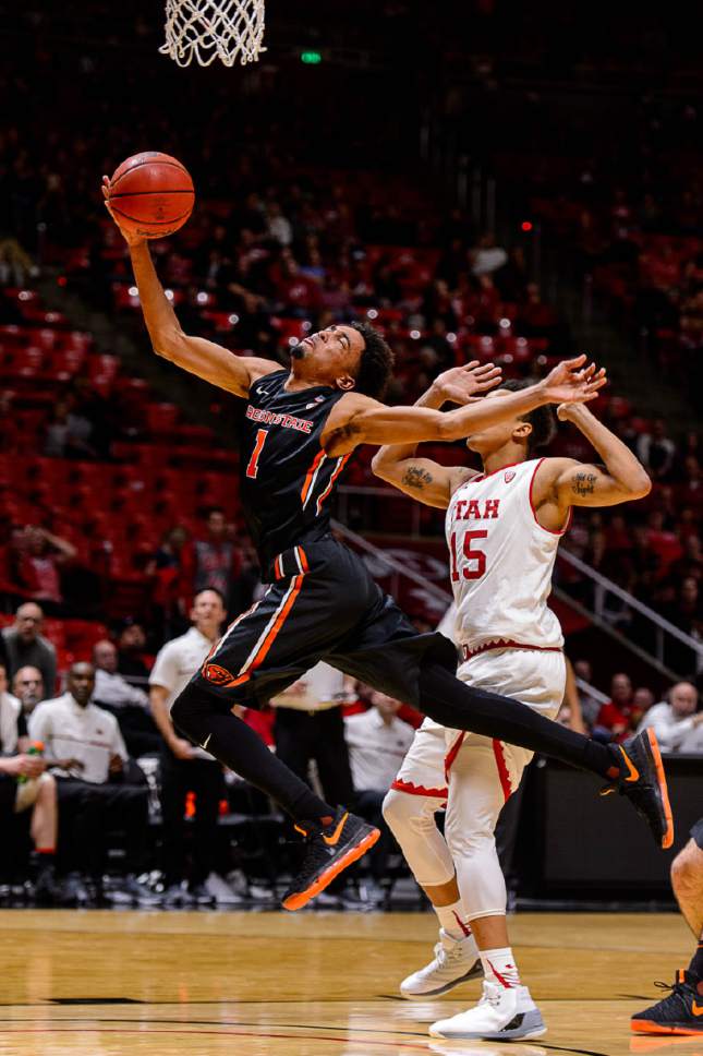 Trent Nelson  |  The Salt Lake Tribune
Oregon State Beavers guard Stephen Thompson Jr. (1) puts up a shot ahead of Utah Utes guard Lorenzo Bonam (15) as the University of Utah hosts Oregon State, NCAA basketball at the Huntsman Center in Salt Lake City, Saturday January 28, 2017.
