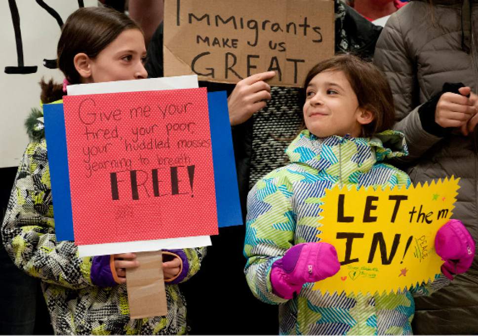 Michael Mangum  |  Special to the Tribune

Avery Kraatz, 10 years old (left), and Millie Kraatz, 8 years old, stand together during a protest at the Salt Lake City International Airport on Saturday, January 28, 2017.The Kraatz's mother said it was their idea to come and participate. "I don't think it's fair to not let them in just because they're different," Millie said.