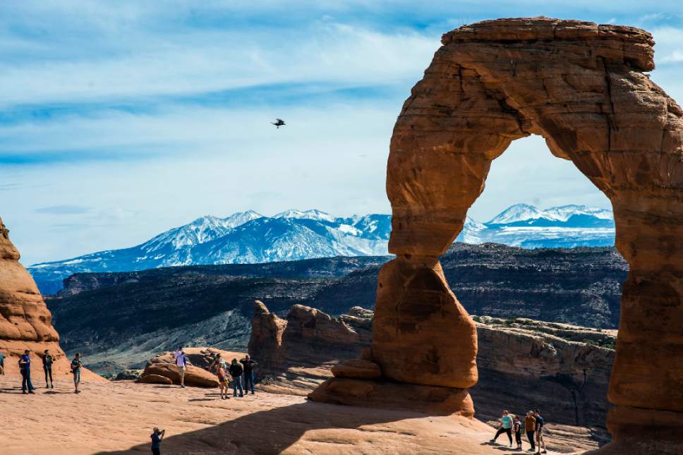 Chris Detrick  |  Tribune file photo
Visitors take pictures and hike around Delicate Arch in Arches National Park Saturday March 5, 2016. As yearly visitation numbers continue to rise, a recently announced federal hiring freeze could create major problems in U.S. national parks.