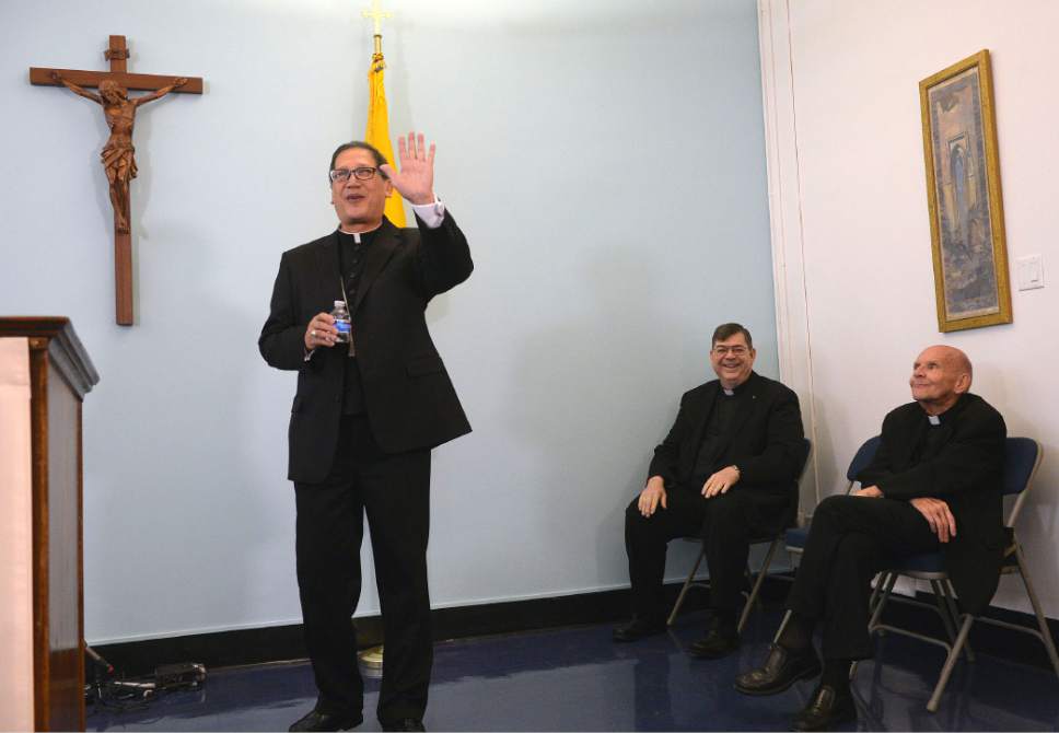 Al Hartmann  |  The Salt Lake Tribune 
Bishop elect Oscar Azarcon Solis, left, waves as he's introduced as the 10th Bishop of the Catholic Diocese of Salt Lake City Tuesday Jan. 10.  Msgr. Colin Bircumshaw and Msgr. Terrence Fitzgerald at right.