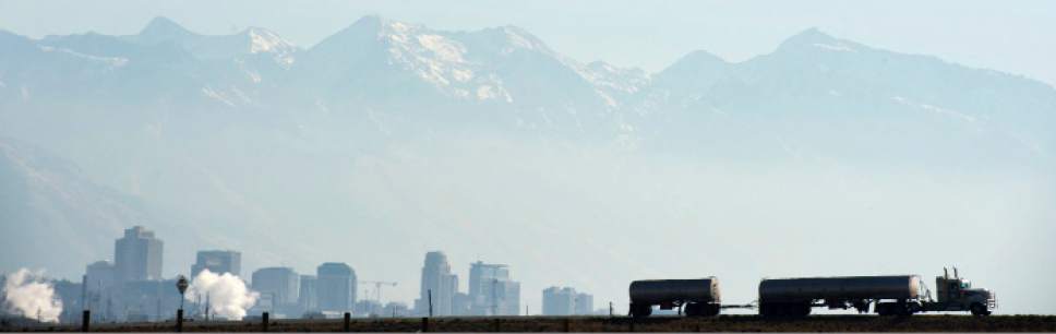 Steve Griffin  |  The Salt Lake Tribune

A semitrailer makes its way onto I-215 near North Salt Lake as the Salt Lake City skyline and the Wasatch mountains peak out of the haze Monday, November 17, 2014.