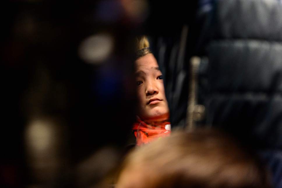 Trent Nelson  |  The Salt Lake Tribune
Refugee Fatima Hassan Barat looks on as a large group welcomes her Afghan family (Hassan Ali, his wife Fozia, and their five children) to the Salt Lake City International Airport, Thursday February 2, 2017. The family members are likely the last refugees to arrive in Utah for the foreseeable future, as President Donald Trump's immigration ban takes effect.