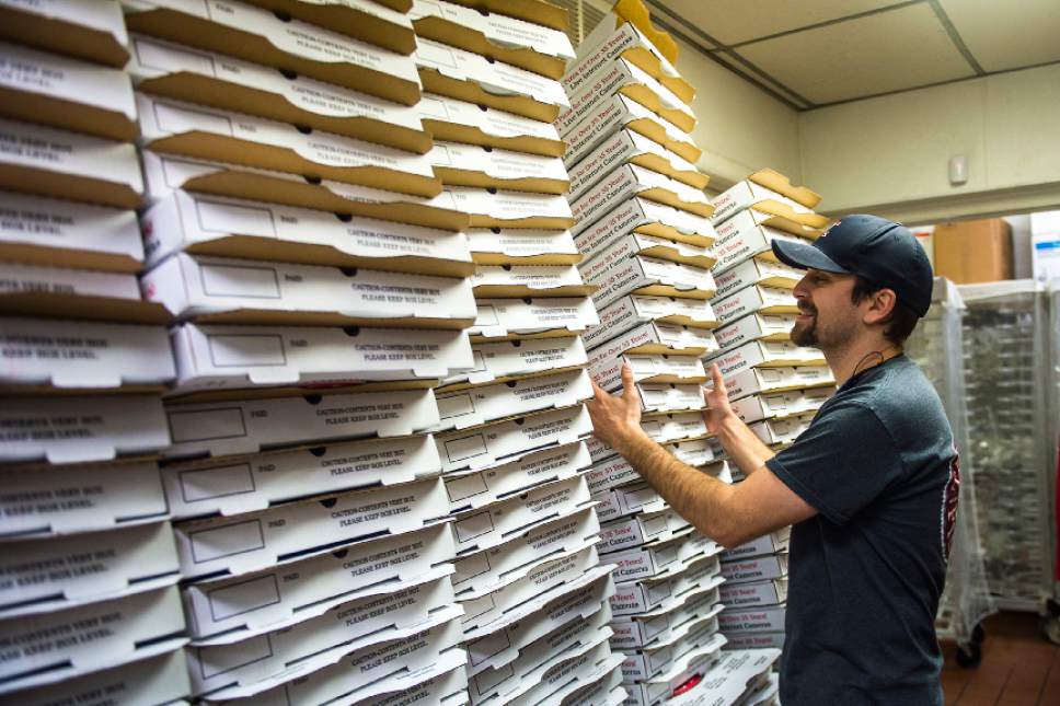 Chris Detrick  |  The Salt Lake Tribune
Manager Zach Kellogg stacks pizza boxes at The Pie Pizzeria in Salt Lake Cityon  Friday.