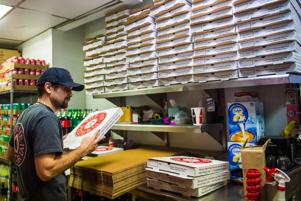 Chris Detrick  |  The Salt Lake Tribune
Manager Zach Kellogg folds pizza boxes at The Pie Pizzeria in Salt Lake City Friday February 3, 2017.
