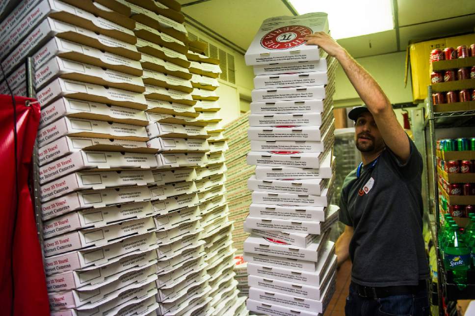 Chris Detrick  |  The Salt Lake Tribune
Manager Zach Kellogg carries a stack of pizza boxes at The Pie Pizzeria in Salt Lake City Friday February 3, 2017.