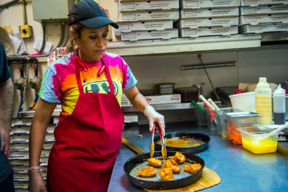 Chris Detrick  |  The Salt Lake Tribune
Kitchen manager Patricia Benitez prepares an order of wings at The Pie Pizzeria in Salt Lake City Friday February 3, 2017.
