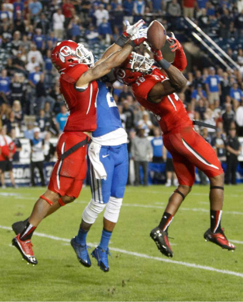 Trent Nelson  |  The Salt Lake Tribune
Utah Utes defensive back Davion Orphey (11) and Utah Utes defensive back Eric Rowe (18) keep the ball away from Brigham Young Cougars wide receiver Cody Hoffman (2) late in the fourth quarter as the BYU Cougars host the Utah Utes, college football Saturday, September 21, 2013 at LaVell Edwards Stadium in Provo.