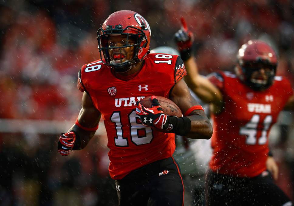 Scott Sommerdorf   |  The Salt Lake Tribune
As Utah LB Jared Norris celebrates at right, DB Eric Rowe crosses the goal line with an INT to give Utah a very quick 7-0 lead. Utah took a 21-0 lead over Washington State in the first quarter, Saturday, September 27, 2014.