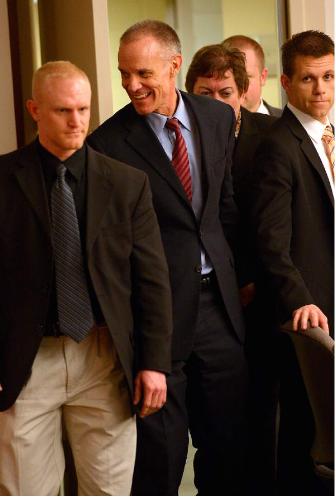 Leah Hogsten  |  The Salt Lake Tribune
Marc Sessions Jenson smiles at three family members as he enters the courtroom to hear the verdict. Jenson was found not guilty Friday, January 30, 2015 of fraud and money laundering in connection with the failed Mount Holly golf and ski resort near Beaver ó a case with ties to the bribery and corruption investigation of former Utah attorneys general Mark Shurtleff and John Swallow.
Following a three-week trial, a jury of five men and three women deliberated 14 hours over two days before acquitting Jenson of four counts each of second-degree felony communications fraud and money laundering.
