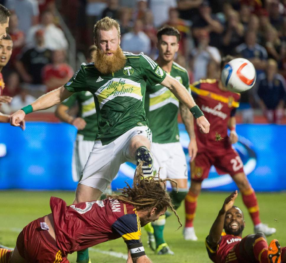 FILE--In this Aug. 15, 2015, file photo, Portland Timbers defender Nat Borchers connects with the ball during an MLS soccer match against Real Salt Lake in Sandy, Utah. Borchers has retired after a 14-year Major League Soccer career. (Rick Egan/The Salt Lake Tribune via AP, file)
