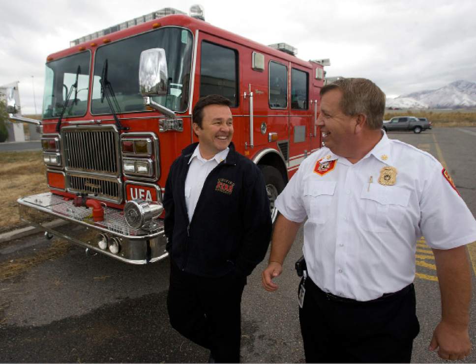 Al Hartmann  |  Tribune file photo

Former Unified Fire Authority Chief Michael Jensen, left, and Deputy Chief Gaylord Scott in October 2010. A recent audit recommends a criminal investigation related to their spending at UFA.