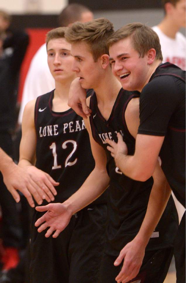 Leah Hogsten  |  The Salt Lake Tribune
Lone Peak's Steven Ashworth is congratulated for his play in the game by Braden Bromley. Lone Peak High School boys' basketball team defeated American Fork High School 72-69 during their game Friday, February 3, 2017 in American Fork.