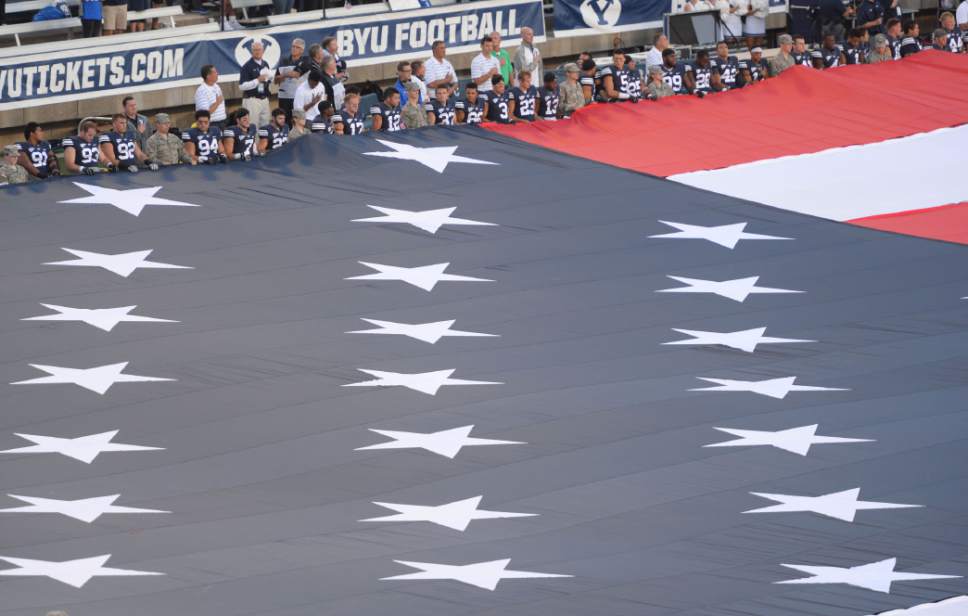 Steve Griffin  |  The Salt Lake Tribune


A giant American Flag is held by BYU Army and Air Force ROTC members as well as the BYU and Houston football players in honor of the anniversary of 911 before the start of the game between BYU and Houston and LaVell Edwards Stadium in Provo, Thursday, September 11, 2014.