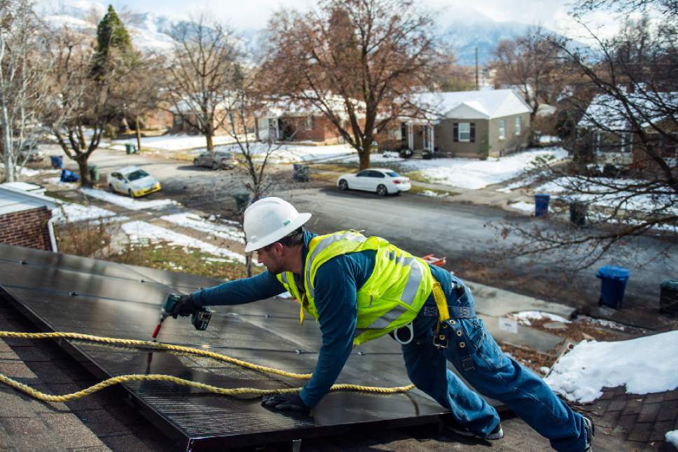 Chris Detrick  |  Tribune file photo
Creative Energies lead electrician Justin Therrien installs solar panels on top of a home in Salt Lake City Wednesday December 7, 2016. A new report says jobs in Utah's solar industry grew by 65 percent last year, as installations of residential solar arrays surged.