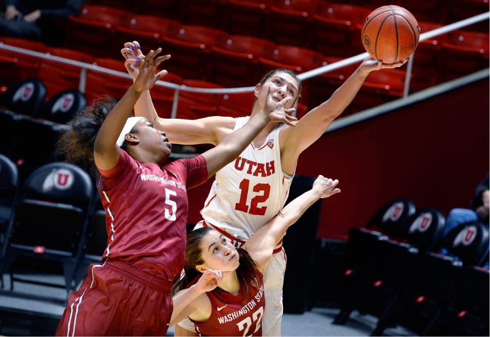 Scott Sommerdorf   |  The Salt Lake Tribune  
Utah Utes forward Emily Potter (12) reaches for a rebound while sandwiched between Washington State Cougars forward Kayla Washington (5) and Washington State Cougars guard Pinelopi Pavlopoulou (22) during first half play. Washington State led Utah 27-22 at the half, Sunday, February 5, 2017.