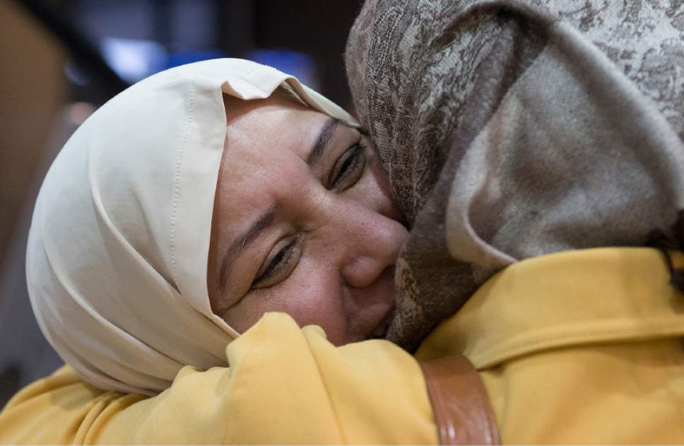 Leah Hogsten  |  The Salt Lake Tribune
l-r  Nisreen Alsaadi smiles as she is hugged by repeatedly by her sister-in-law, Iman Alsaadi  during their greeting for the first time in seven years at the Salt Lake International Airport, February 8, 2017. Nisreen Alsaadi and her son Zaid Alsaadi were allowed to come to the U.S. after a judge on Friday temporarily blocked President Donald Trump's ban on people from seven predominantly Muslim countries from entering the United States.