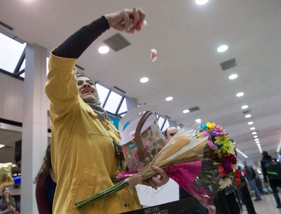 Leah Hogsten  |  The Salt Lake Tribune
Iman Alsaadi throws candy into the air and yells in a high  high-pitch ululation at the sight of her Iraqi sister-in-law and nephew for the first time in seven years at the Salt Lake International Airport, February 8, 2017. A U.S. judge on Friday temporarily blocked President Donald Trump's ban on people from seven predominantly Muslim countries from entering the United States.