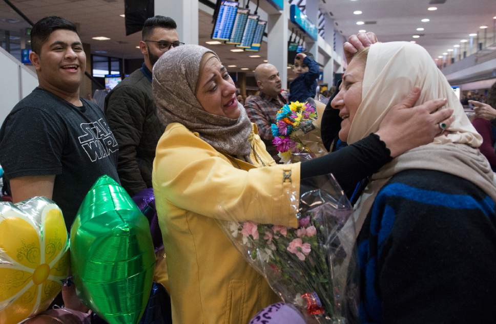 Leah Hogsten  |  The Salt Lake Tribune
Iman Alsaadi and her Iraqi sister-in-law, Nisreen Alsaadi pause from greeting to fix Alsaadi's head scarf upon seeing each other for the first time in seven years at the Salt Lake International Airport, February 8, 2017. At left is Iman's son Ahmed Al-Hayani, 15. Nisreen Alsaadi and her son Zaid Alsaadi were allowed to come to the U.S. after a judge on Friday temporarily blocked President Donald Trump's ban on people from seven predominantly Muslim countries from entering the United States.